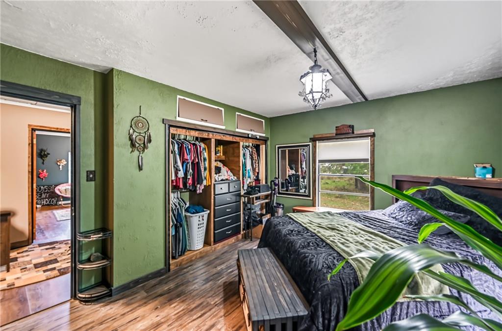 3575 Morefield Road Hermitage, PA 16148 - Photo 26 of 39 a bedroom with a bed painting on wall and a large window