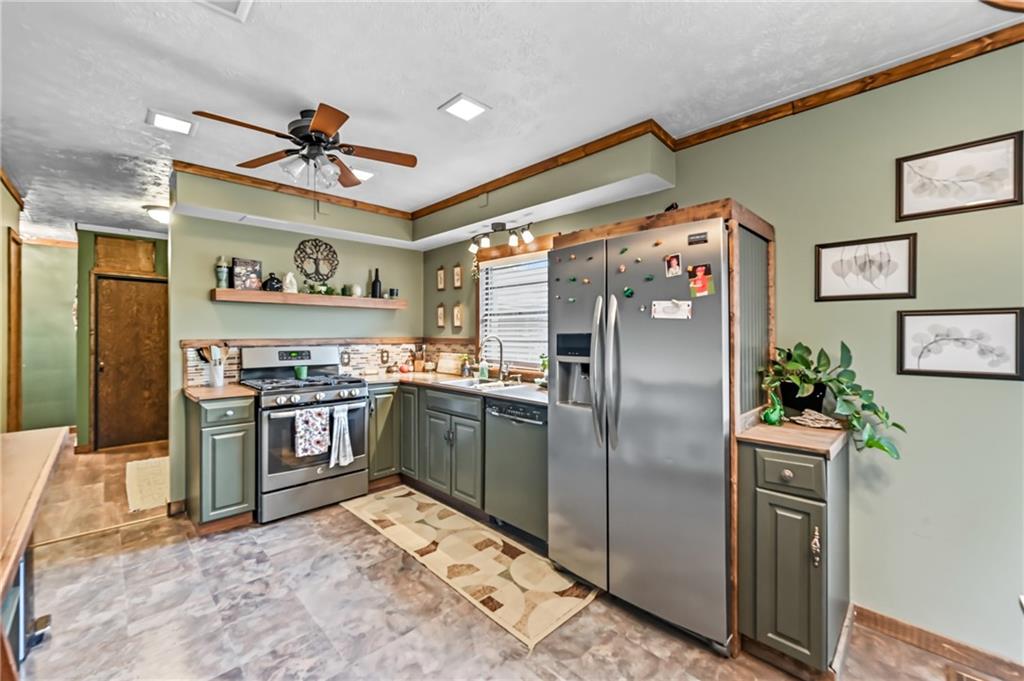 3575 Morefield Road Hermitage, PA 16148 - Photo 9 of 39 a kitchen with stainless steel appliances granite countertop a refrigerator and a stove