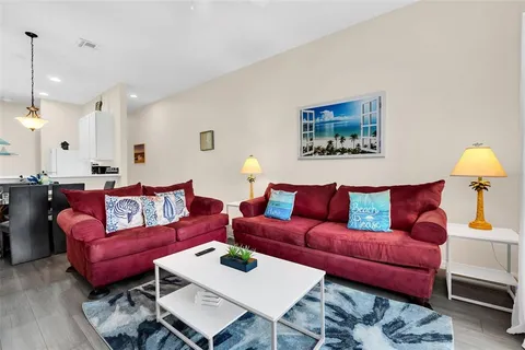 a living room with furniture and a lamp