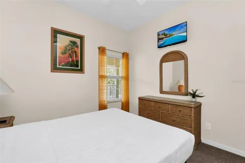 a bedroom with a bed and a painting on the wall