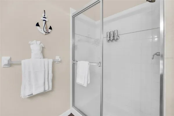 a bathroom with a shower and a glass door