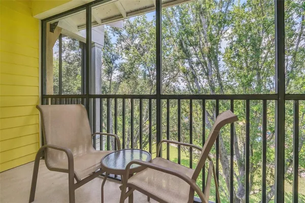 a view of a chair and table in the balcony