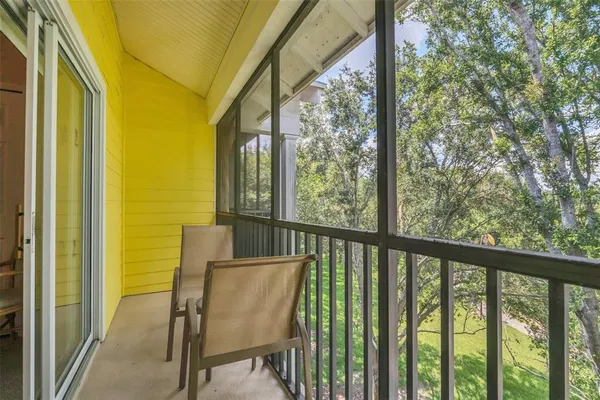 a view of a chair and table in the balcony