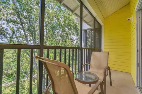 a view of a chair and table in the balcony