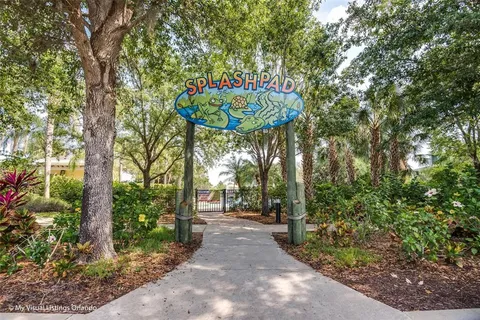 a front view of a house with a tree