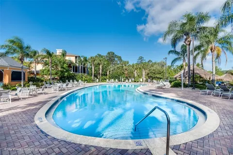 a view of swimming pool with outdoor seating and plants