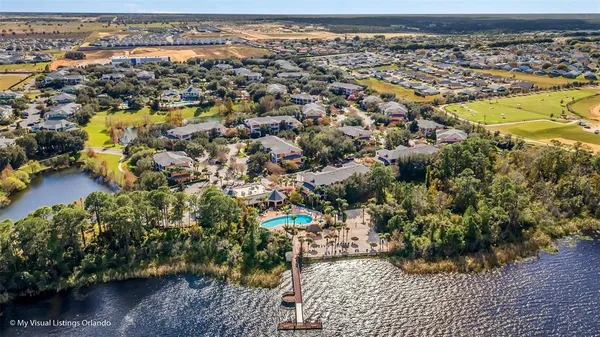 an aerial view of residential houses with outdoor space and swimming pool