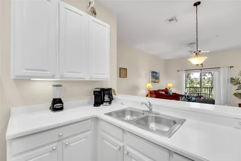 a kitchen with sink cabinets and window