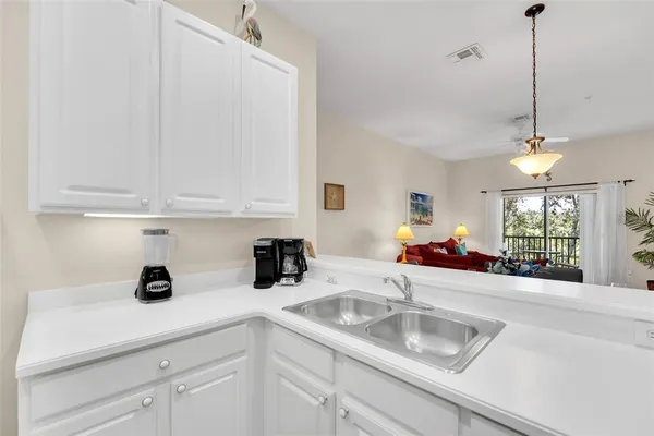a kitchen with sink cabinets and window