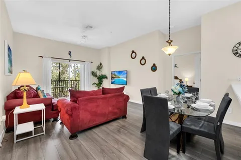 a living room with furniture fireplace and wooden floor