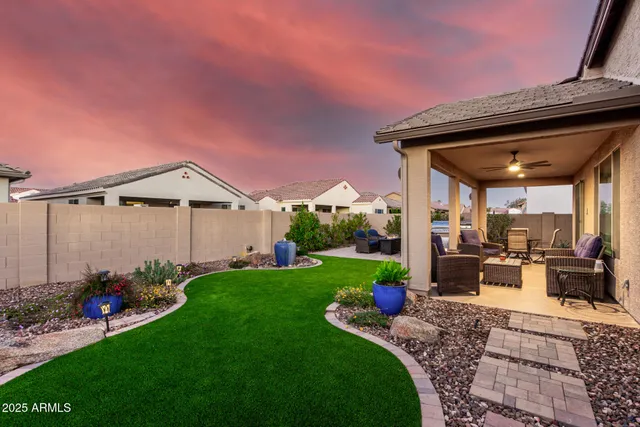 a view of outdoor sitting area with furniture and wooden fence