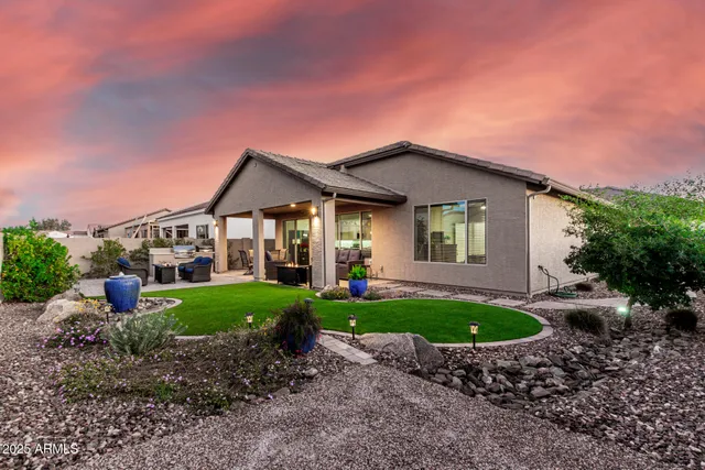 a front view of a house with a garden and yard