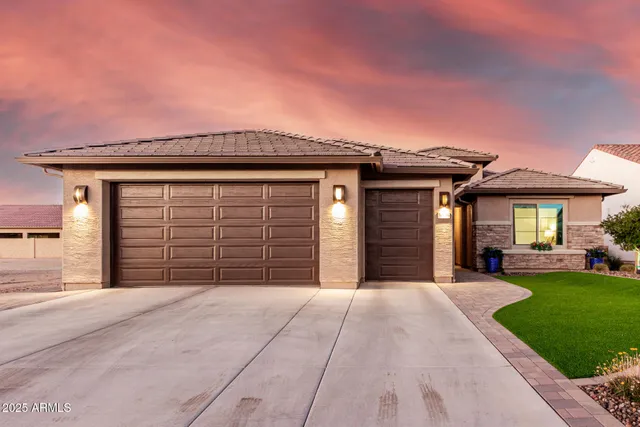 a front view of a house with a yard and garage