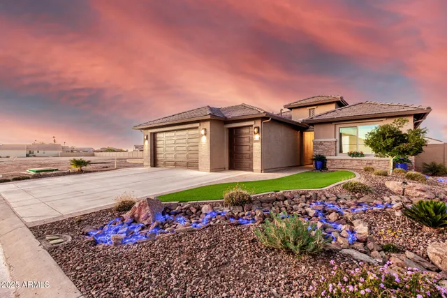 a front view of a house with a garden