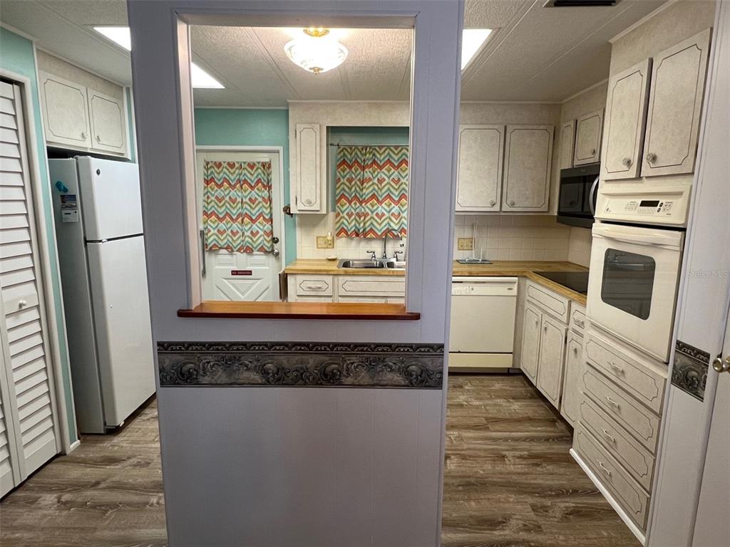 709 Sugar Palm Street Largo, FL 33778 - Photo 11 of 34 a kitchen with stainless steel appliances granite countertop a refrigerator and a stove