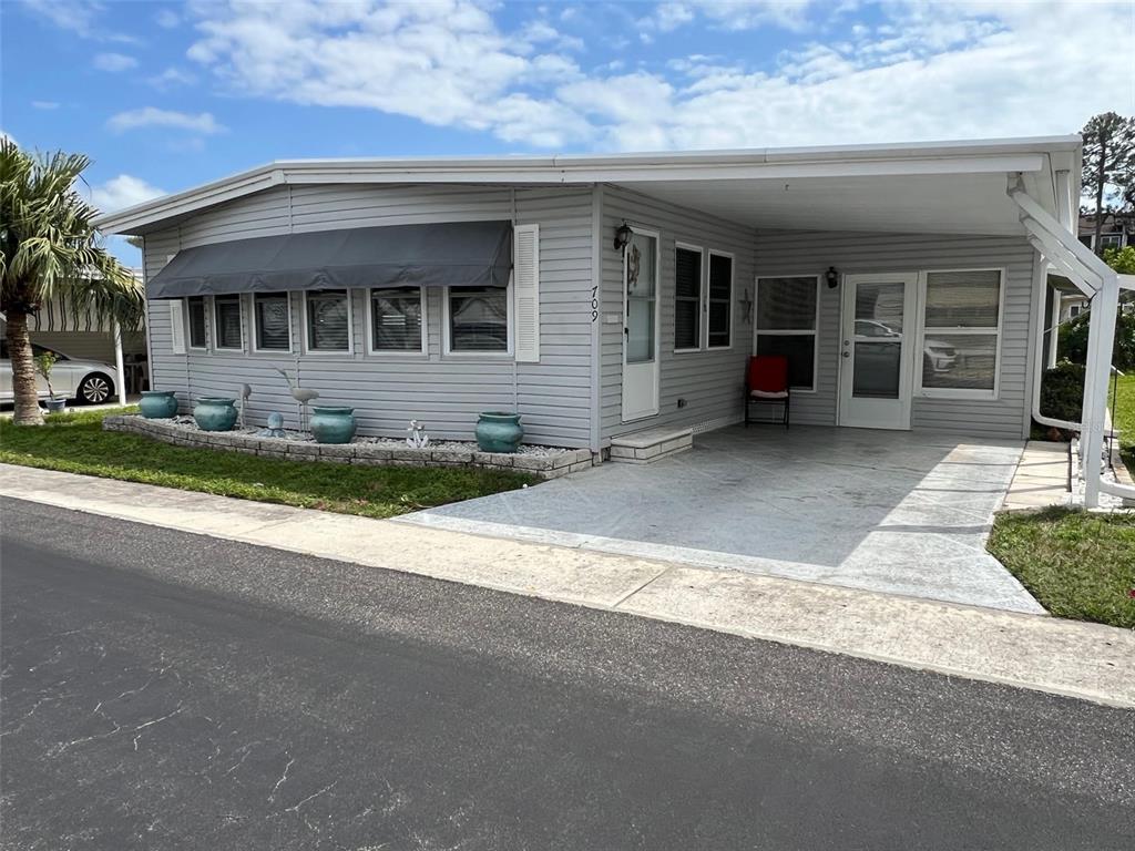 709 Sugar Palm Street Largo, FL 33778 - Photo 2 of 34 a front view of house with yard outdoor seating and garage