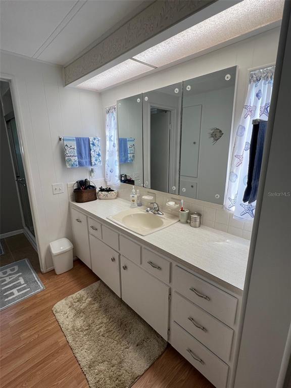 709 Sugar Palm Street Largo, FL 33778 - Photo 21 of 34 a spacious bathroom with a double vanity sink a mirror and a shower