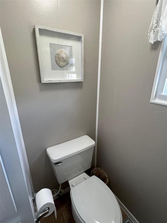 709 Sugar Palm Street Largo, FL 33778 - Photo 24 of 34 a white toilet sitting next to a sink