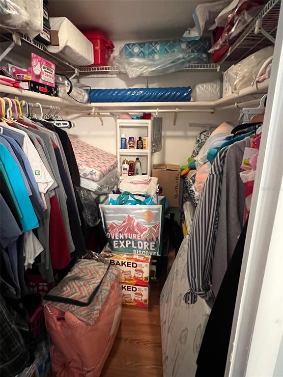 709 Sugar Palm Street Largo, FL 33778 - Photo 28 of 34 a view of walk in closet with clothes and shoes