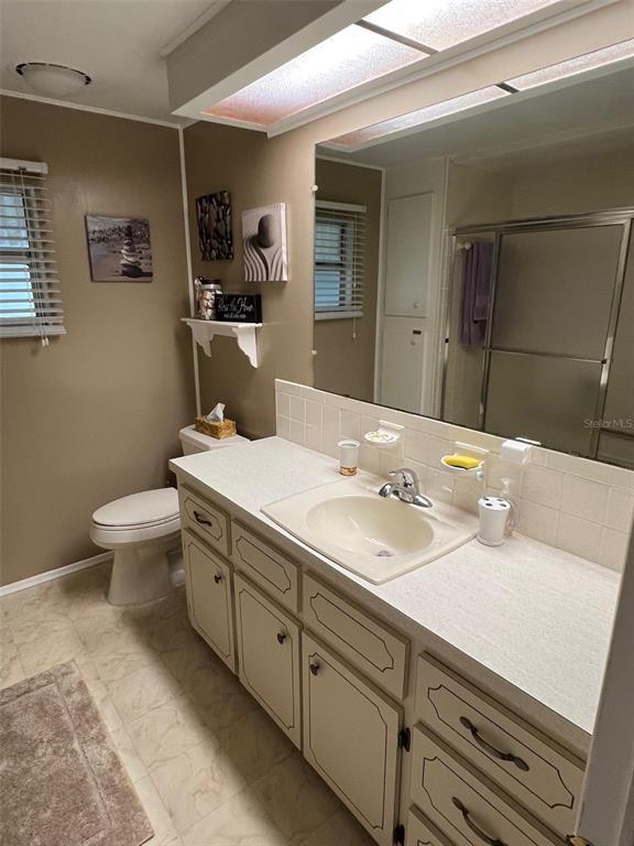 709 Sugar Palm Street Largo, FL 33778 - Photo 30 of 34 a bathroom with a sink and a mirror
