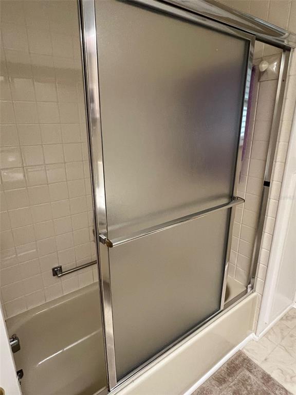 709 Sugar Palm Street Largo, FL 33778 - Photo 31 of 34 a bathroom with a glass shower door