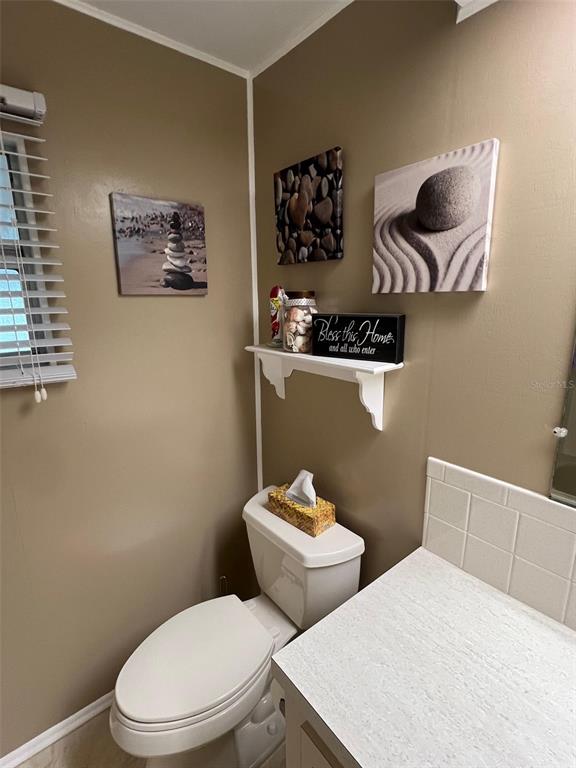 709 Sugar Palm Street Largo, FL 33778 - Photo 32 of 34 a white toilet sitting next to a bathroom sink