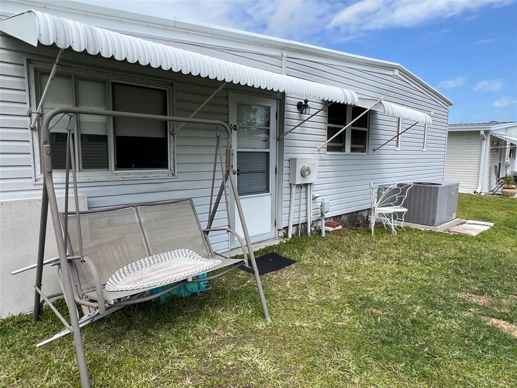709 Sugar Palm Street Largo, FL 33778 - Photo 4 of 34 a backyard of a house with seating space