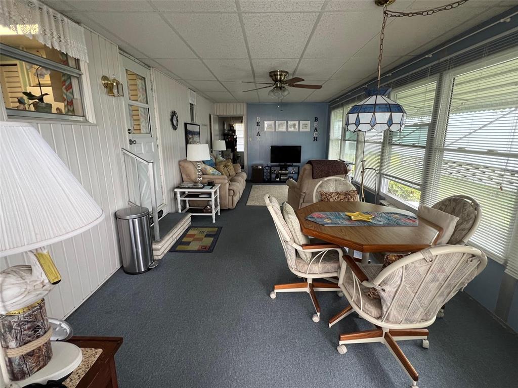 709 Sugar Palm Street Largo, FL 33778 - Photo 6 of 34 a dining room with furniture windows and a chandelier
