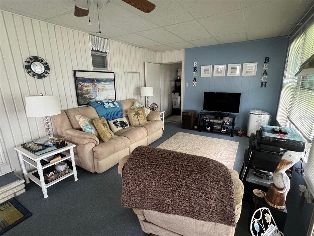 709 Sugar Palm Street Largo, FL 33778 - Photo 7 of 34 a living room with furniture a flat screen tv and a fireplace