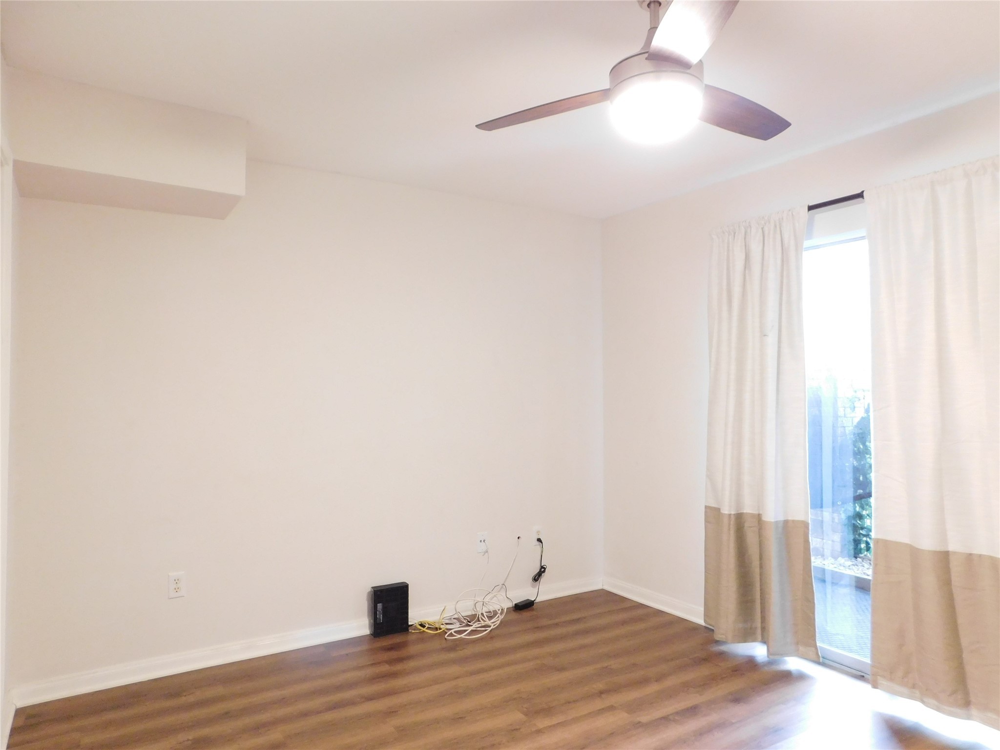 10101 South Gessner Road, Unit 912 Houston, TX 77071 - Photo 27 of 47 a view of empty room with wooden floor and fan