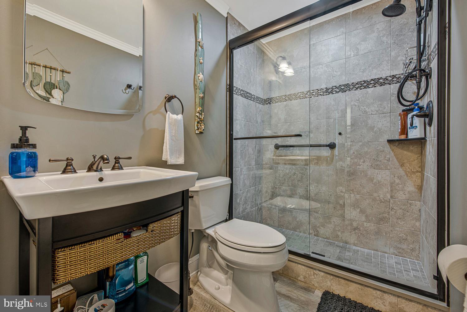 902 Locustvale Road Towson, MD 21204 - Photo 14 of 35 a bathroom with a sink mirror toilet and shower