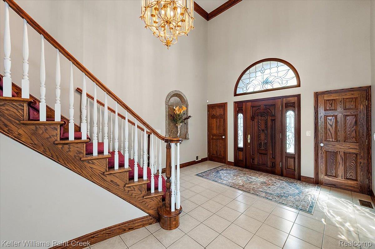 69069 Campground Road Romeo, MI 48065 - Photo 19 of 78 Two-story foyer featuring a grand staircase with wood treads and white balusters