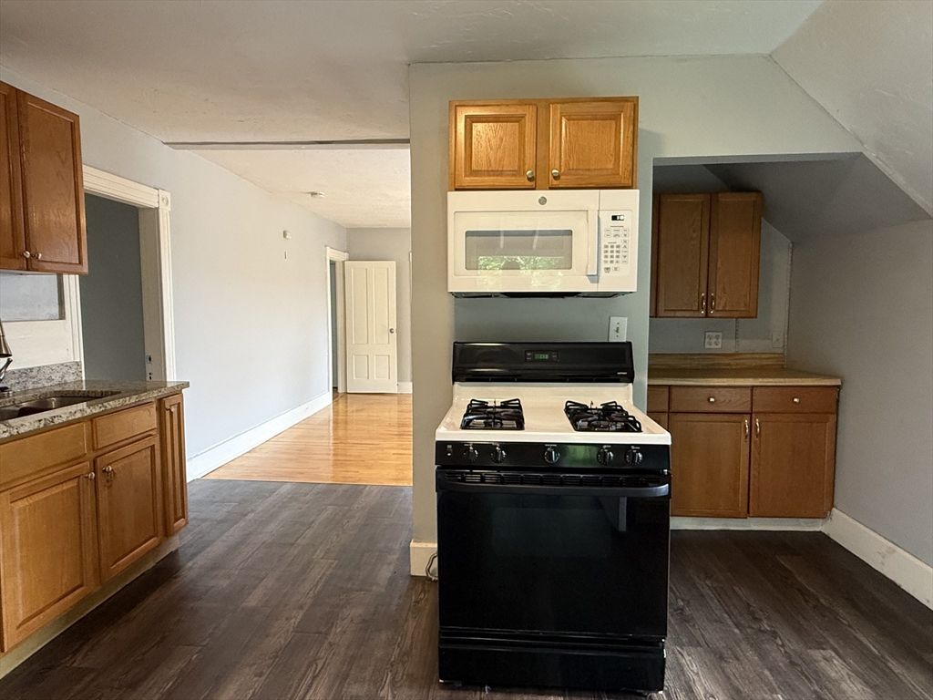5 Arbor Vitae Street, Unit 2 Worcester, MA 01603 - Photo 4 of 12 a kitchen with stainless steel appliances granite countertop a stove a sink and a refrigerator