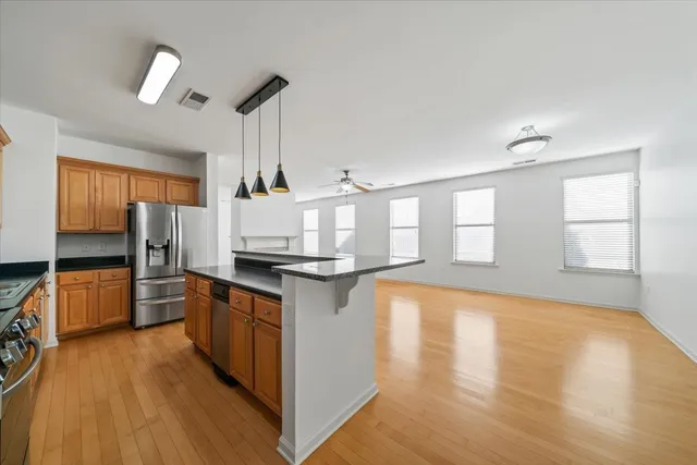 a kitchen with stainless steel appliances granite countertop a stove and a refrigerator