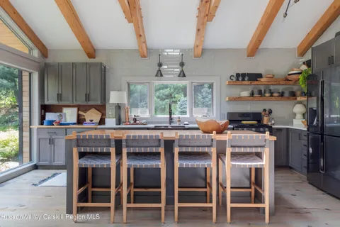 a kitchen with a table chairs sink and cabinets