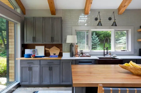 a kitchen with stainless steel appliances granite countertop a sink dishwasher and cabinets with wooden floor