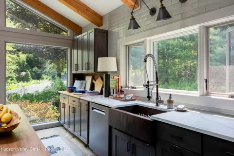 a kitchen with a sink and a large window