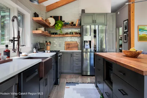a kitchen with stainless steel appliances granite countertop a stove a sink and a refrigerator