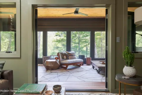 a living room with furniture and a floor to ceiling window
