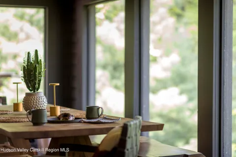 a view of a dining room with furniture and window