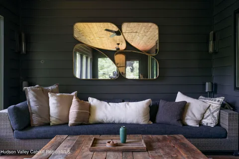 a living room with furniture and a mirror