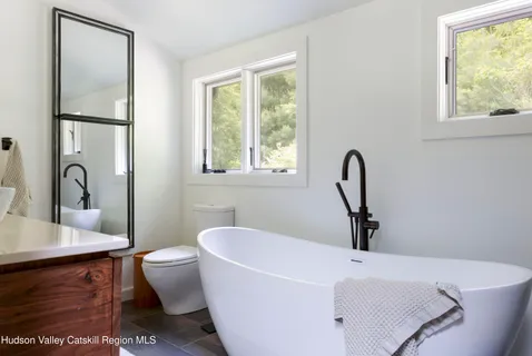 a white bath tub sitting next to a white sink