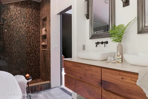 a bathroom with a granite countertop sink and a mirror