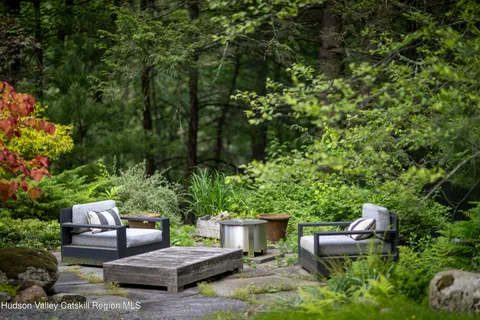 a backyard of a house with outdoor seating