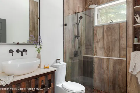 a bathroom with a sink toilet and shower