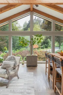 a dining room with furniture and wooden floor