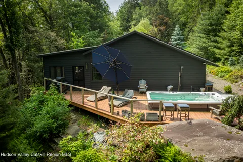 a view of a wooden chairs and table in the patio