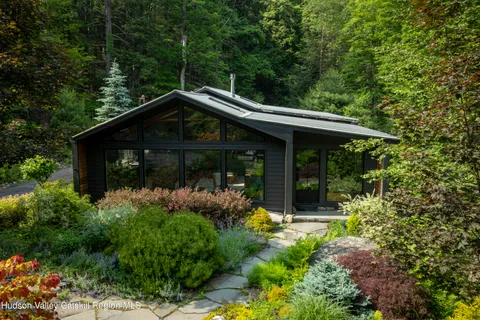 a front view of a house with garden