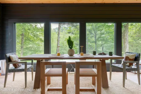 a view of a dining room with furniture and window