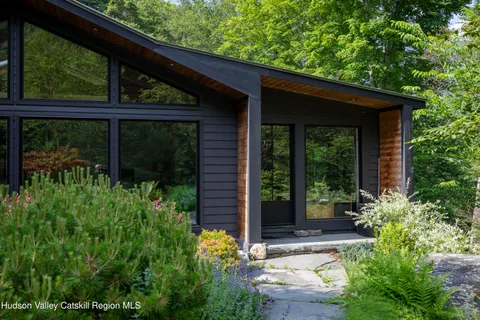 a view of house with backyard and outdoor seating